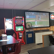 Dart board next to a tv at Falls Bowl in Chippewa Falls WI.